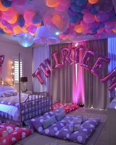 a bedroom decorated in purple, pink and blue balloons with the word surprise on it