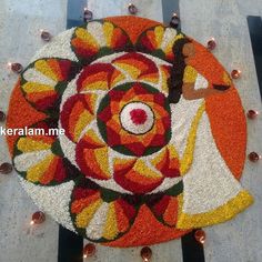 this is an image of a colorful flower design on the ground