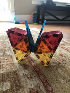 two colorful glass objects sitting on top of a rug