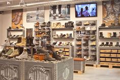 there are many pairs of shoes on display in the store's shoe rack area