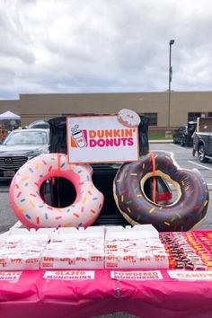 donuts and doughnuts are on display in the parking lot