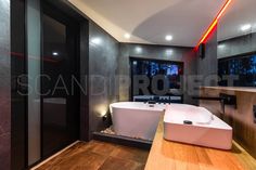 a bathroom with a large bathtub next to a walk in shower and wooden floors