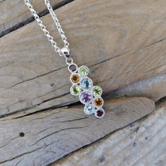 Multi stone necklace...1 1/2" tall with bail by 1/2" wide at the widest spot, cast in sterling silver 925 with 2 citrines, 2 garnets, 2 blue topaz, 3 peridots and 1 amethyst...all are bezel set...the chain is 18" long also in sterling silver 925 with a lobster catch...this necklace is very beautiful and brilliant..... Multicolor Sterling Silver Birthstone Necklace, Silver Birthstone Pendant Necklace, Silver Pendant Birthstone Necklace With Natural Stones, Silver Birthstone Pendant Necklace With Natural Stones, Sterling Silver Multi-stone Pendant Gemstones, Sterling Silver Multi-stone Pendant, Silver Pendant Necklace With Peridot, Blue Topaz Pendant, Citrine Necklace