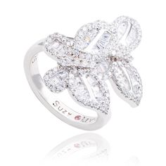 With elegance and subtlety, this Suzy Levian butterfly collection creation has become an icon of class, luxury and style. Let your creative side shine through with this whimsical double butterfly ring featuring white round and baguette shape cubic zirconia, hand set in sterling silver. This ring is designed by Suzy Levian with a message. By creating jewelry that is beautiful inside and out, Suzy Levian 's message is revealed through a hidden stone set inside the shank of this ring to empower wom Double Butterfly, Ladies Rings, Butterfly Collection, Butterfly Ring, Detailed Ring, Beautiful Inside And Out, Creating Jewelry, Stone Settings, Metal Stamping