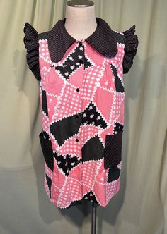 a pink and black dress on a mannequin