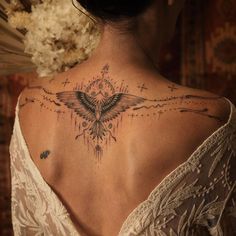 a woman with a tattoo on her back