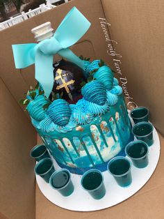 a cake with blue icing and decorations in a box