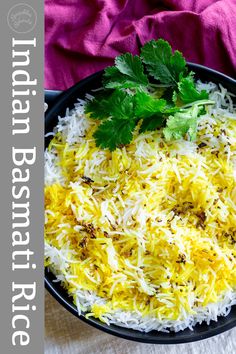 a black bowl filled with rice and garnished with parsley on the side