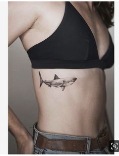 a woman with a shark tattoo on her stomach