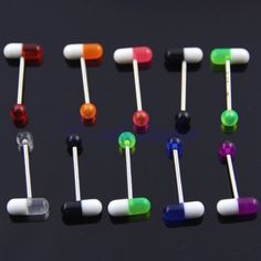 many different colored candy lollipops on a black surface