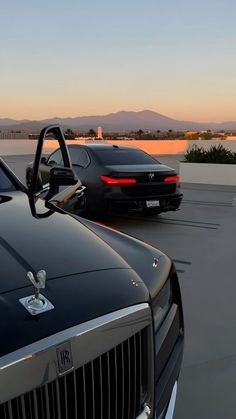 two cars parked next to each other in a parking lot