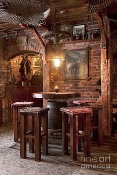 an old fashioned bar with brick walls and wooden stools