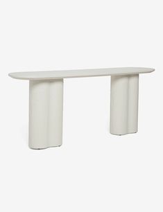 a white table sitting on top of a white floor