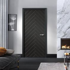 a living room with a fireplace and black doors in the center, surrounded by white marble walls