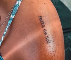 the back of a woman's shoulder with an inscription on it that says,