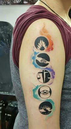 a woman with a tattoo on her arm that has five different symbols in the middle