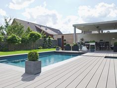 a backyard with a pool and decking area