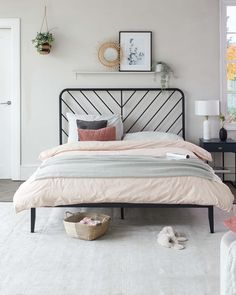 a bedroom with a bed, rug and pictures on the wall