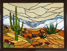 a stained glass window in the shape of a desert scene with cacti and mountains