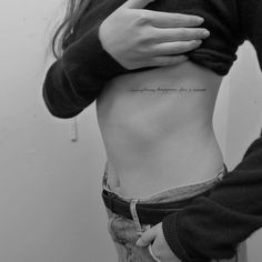 a woman's stomach with the words, nothing happens for a reason written on it