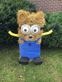 a scarecrow made out of hay with googly eyes