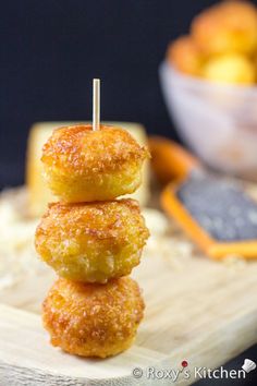 three donuts stacked on top of each other with toothpicks sticking out of them