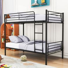 a black bunk bed sitting on top of a wooden floor