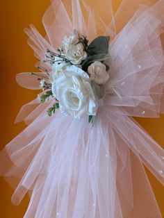 a bridal bouquet with white flowers on an orange background