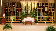 the wedding stage is decorated with flowers and greenery