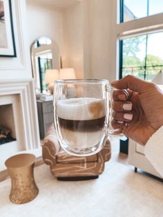 a woman is holding a coffee mug in her hand