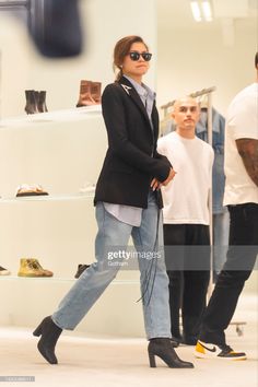 a model walks down the runway wearing high heeled shoes