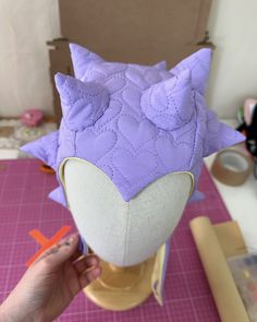 a person is making an animal head out of fabric