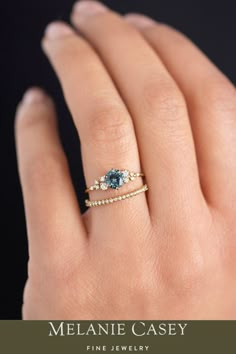 a woman's hand with a ring on it and the words melanie casey fine jewelry