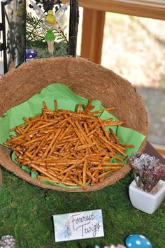 a basket filled with sticks sitting on top of a table next to other items and decorations