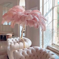 a living room filled with furniture and a large pink ostrich