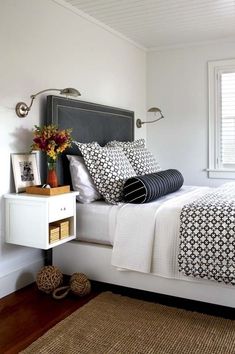 a bedroom with a bed, nightstand and window