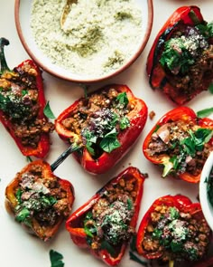 stuffed red peppers with pesto and parmesan cheese on top, ready to be eaten