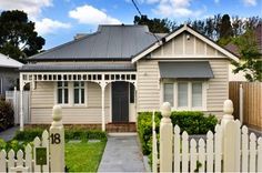 a house with a white picket fence in front of it