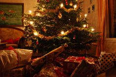 a christmas tree with presents under it in a living room