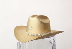 YEEHAW! Our most popular blinged out Cowboy hats are here in perfect metallics! Want it without crystal star? Write "NO STAR" in the notes section! Super limited quantities! Size chart S/M- Has elastic insert making it fit more snug- 24" around but fits 22-26" L/XL-Has elastic insert making it fit more snug- 28" around but fits 26-30" This item is made to order in our Costa Mesa Studio! Gold Cowboy Hat, Crystal Stars, Cowboy Hat, Eras Tour, Cowboy Hats, Cowboy, Most Popular, Outfit Ideas, Size Chart