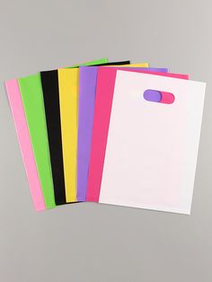 five different colored envelopes on a gray background