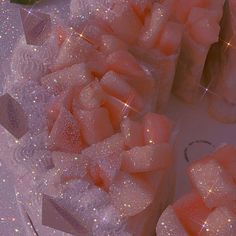 several pink bows are on display in front of some bottles with liquid inside them and sparkles around the edges