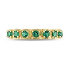 Display your everlasting commitment with this elegant and vintage-inspired green lab-created emerald eternity band. Fashioned in sterling silver with yellow rhodium plate This choice glistens with an endless row of verdant-green lab-created emeralds. Intricate milgrain-lined square-shaped frames add heirloom detail to the style. Emerald is the traditional birthstone for May and symbolizes loyalty, faithfulness and love. Elegant Green Stackable Eternity Band, Classic Green Stackable Eternity Band, Classic Green Eternity Promise Ring, Formal Green Gemstone Eternity Band, Classic Green Eternity Band For Formal Occasions, Classic Green Gemstone Eternity Band, Classic Gemstone Eternity Band For Formal Occasions, Green Emerald Eternity Band Fine Jewelry, Elegant Green Gemstone Eternity Band