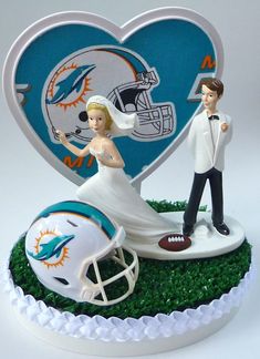 a bride and groom figurine next to a football helmet