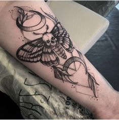 a black and white photo of a tattoo on the arm with a butterfly flying over it