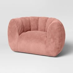 a pink chair sitting on top of a white floor