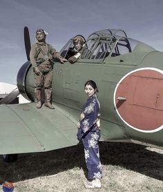 two people standing in front of an old fashioned fighter plane with the pilot on it's wing