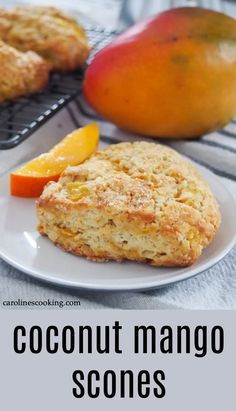 a close up of a plate of food with fruit on the side and text overlay reading coconut mango scones