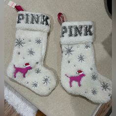 two white christmas stockings with pink dogs on them