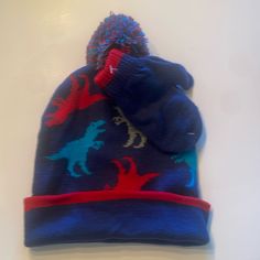 New Without Tags Beanie Has A Dinosaur Pattern And A Pom Pom Mittens Are Blue And Red At The Top 2-4t Dinosaur Pattern, A Dinosaur, Hat Set, Winter Hat, Kids Accessories, The Top, Accessories Hats, Winter Hats, Pom Pom